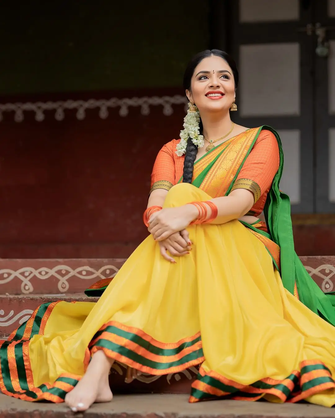 Sreemukhi Stills in Yellow Lehenga Orange Choli Green Voni